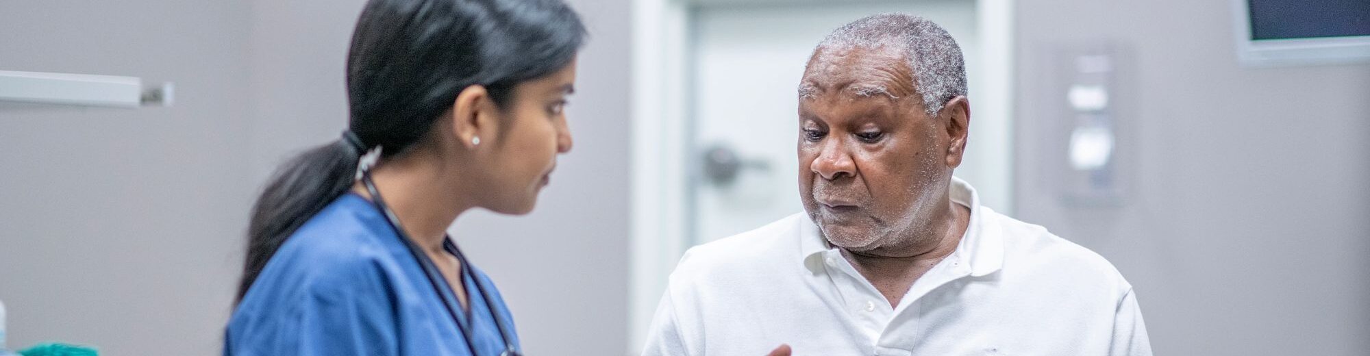 Elderly male patient talking with female doctor 1212821220