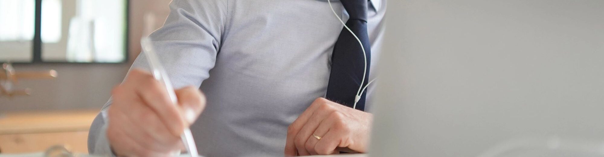 Man writing medical notes while watching laptop screen 120555644