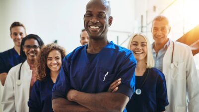 Doctor standing in hospital with his staff 110543898