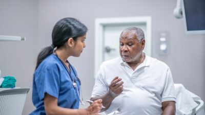 Elderly male patient talking with female doctor 1212821220