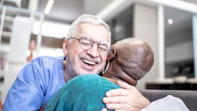 Male nurse embracing patient at home 1182452151