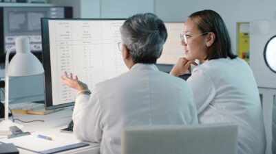 Women and man on computer for medical research in hospital laboratory 1483251775